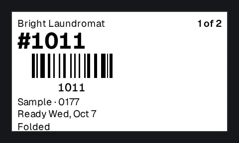 A bag label from Bright Laundromat: the ticket number and its barcode, the customer, the ready-by day and their preference, Folded.