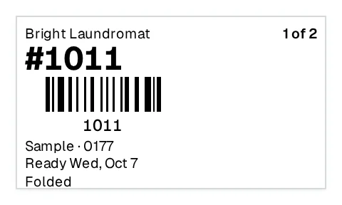 A bag label from Bright Laundromat: the ticket number and its barcode, the customer, the ready-by day and their preference, Folded.