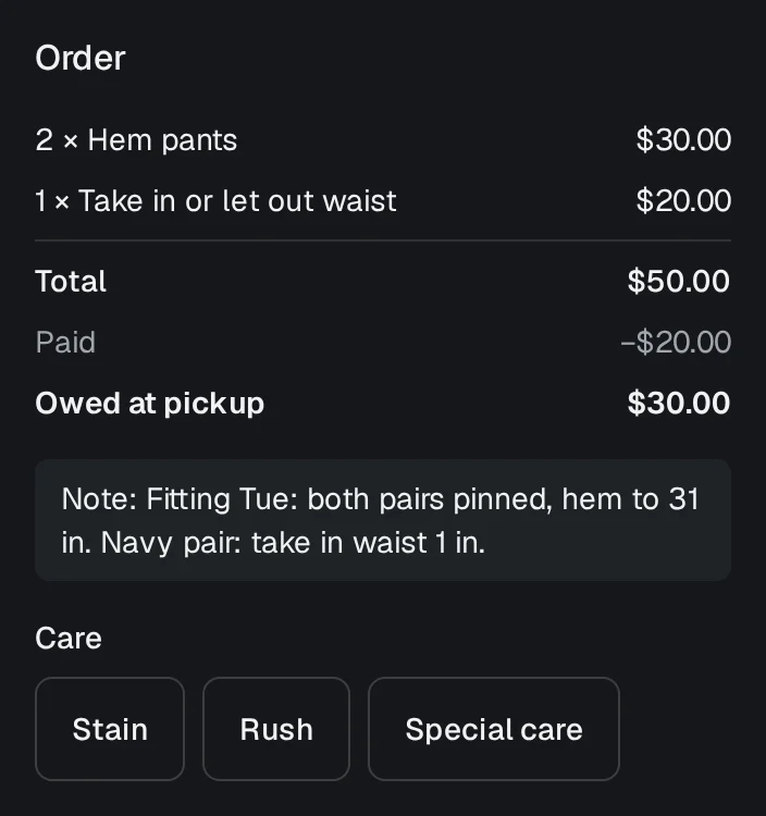 A tailor's ticket: two pairs of pants to hem and a waist to take in, the fitting note underneath, a deposit paid and the rest owed at pickup.